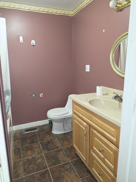 44-th 19th Street, Unit REAR Lowell, MA 01850 - Photo 11 of 13 a bathroom with a sink a toilet and a mirror