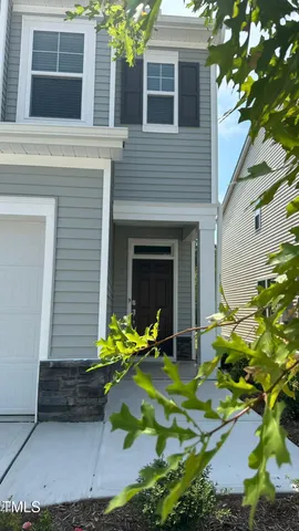 a view of a house with yard and sitting area