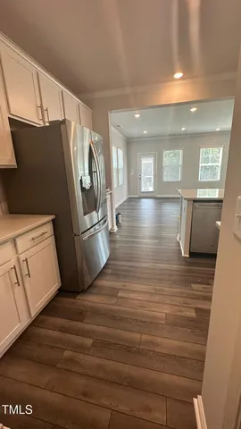 a view of a refrigerator in kitchen and wooden floor