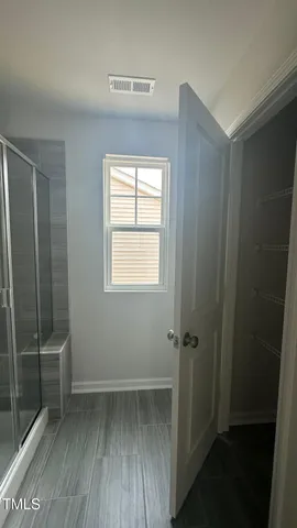 a bathroom with a shower and a sink