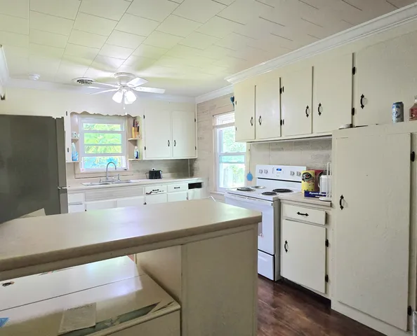 a kitchen with a sink cabinets and window