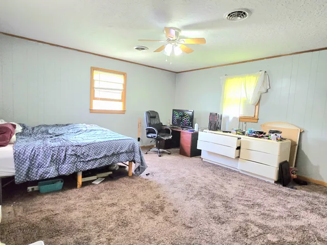 a spacious bedroom with a bed and a table