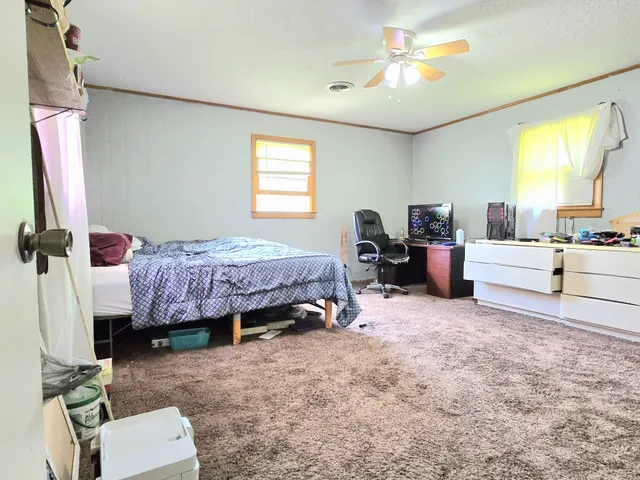 a living room with furniture a bed and a chandelier