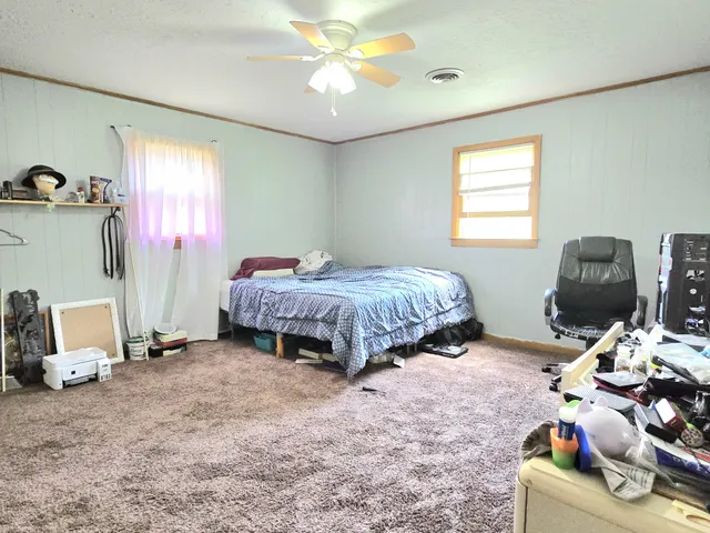 a bedroom with bed and a window