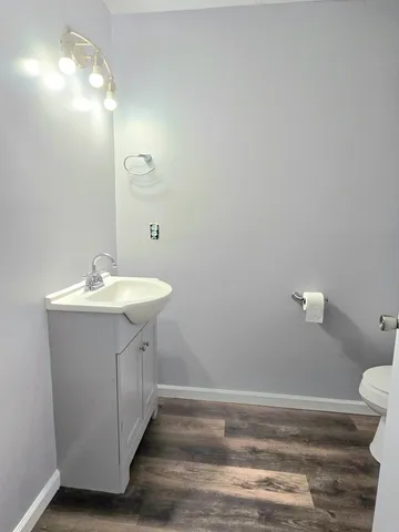 a bathroom with a sink a toilet and a mirror