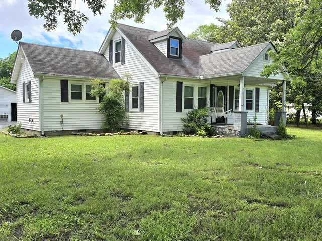 a front view of a house with a yard and porch