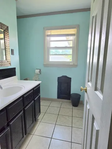 a kitchen with a sink a counter top space and cabinets