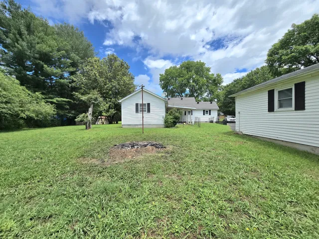 a front view of a house with yard and green space