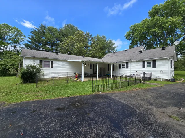 a view of house with outdoor space and garden