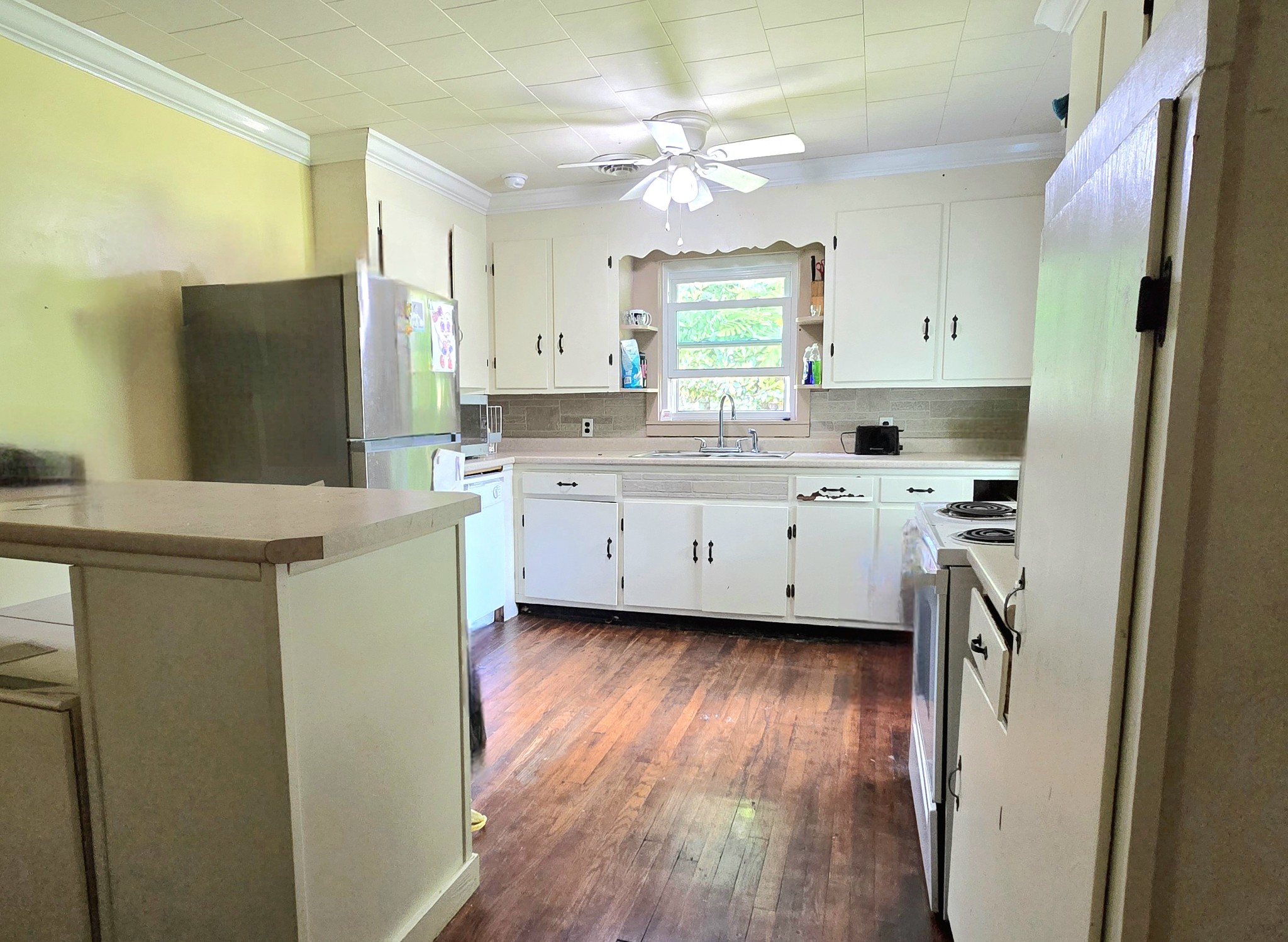 118 Bone Cave Road Rock Island, TN 38581 - Photo 10 of 52 a kitchen with a sink a refrigerator a stove a washer dryer and cabinets