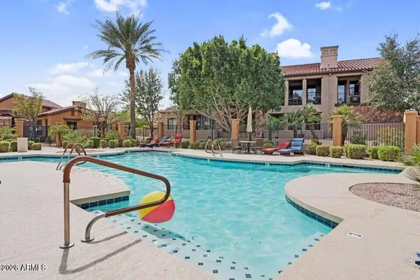 a swimming pool with outdoor seating and yard