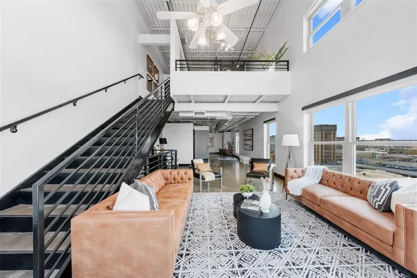 a living room with furniture and a chandelier