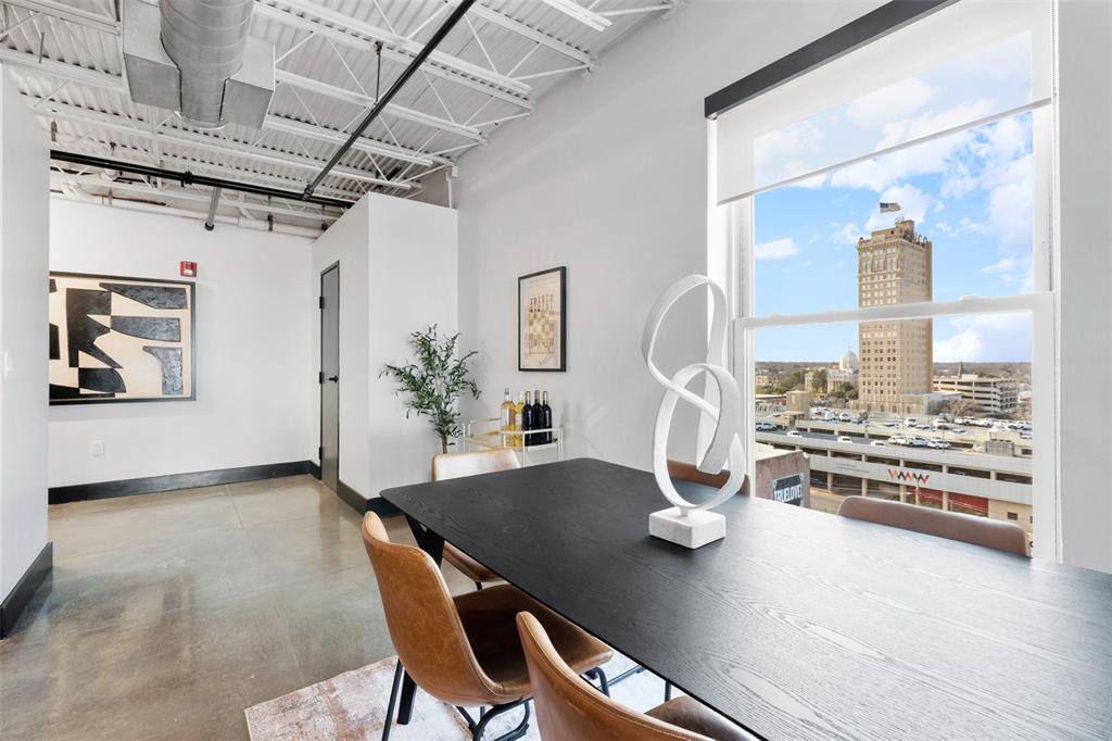 219 South 4th Street, Unit 608 Waco, TX 76701 - Photo 10 of 37 a view of a dining room with furniture a chandelier and wooden floor