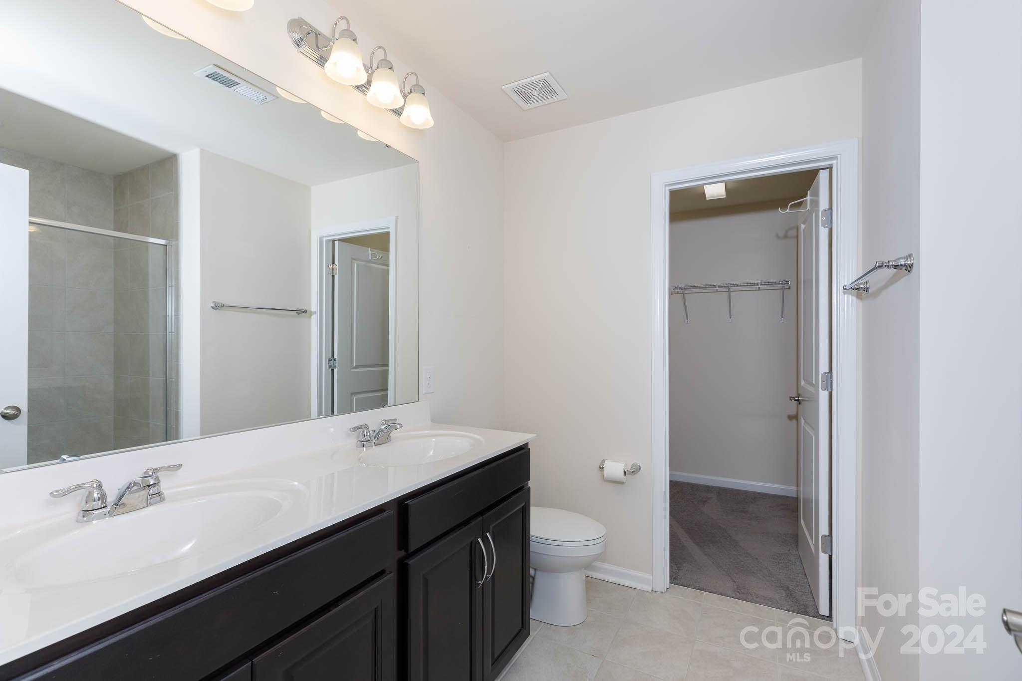 813 Canoe Song Road Fort Mill, SC 29708 - Photo 13 of 26 a bathroom with a double vanity sink mirror and toilet