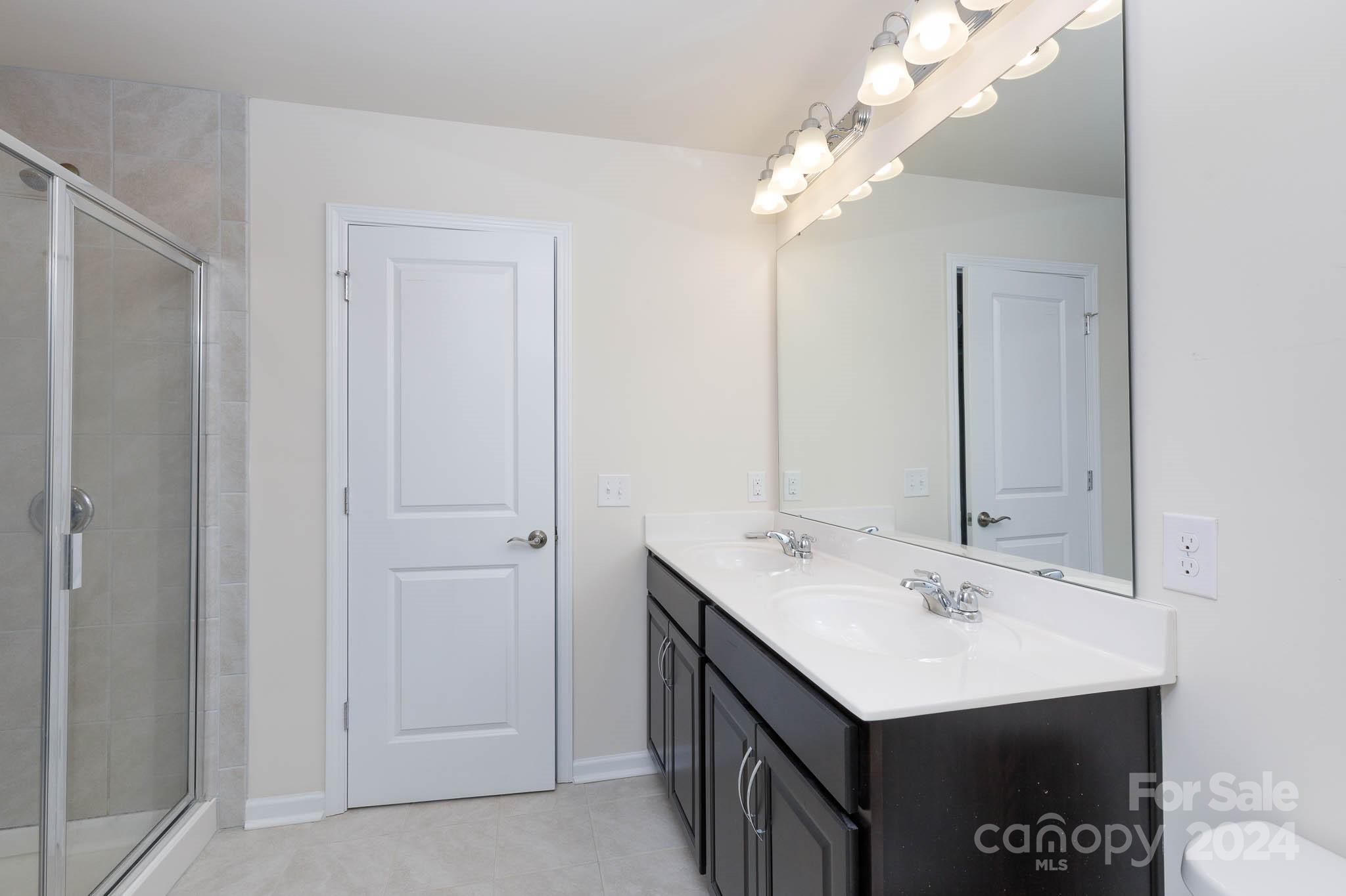 813 Canoe Song Road Fort Mill, SC 29708 - Photo 15 of 26 a bathroom with a sink vanity and a mirror