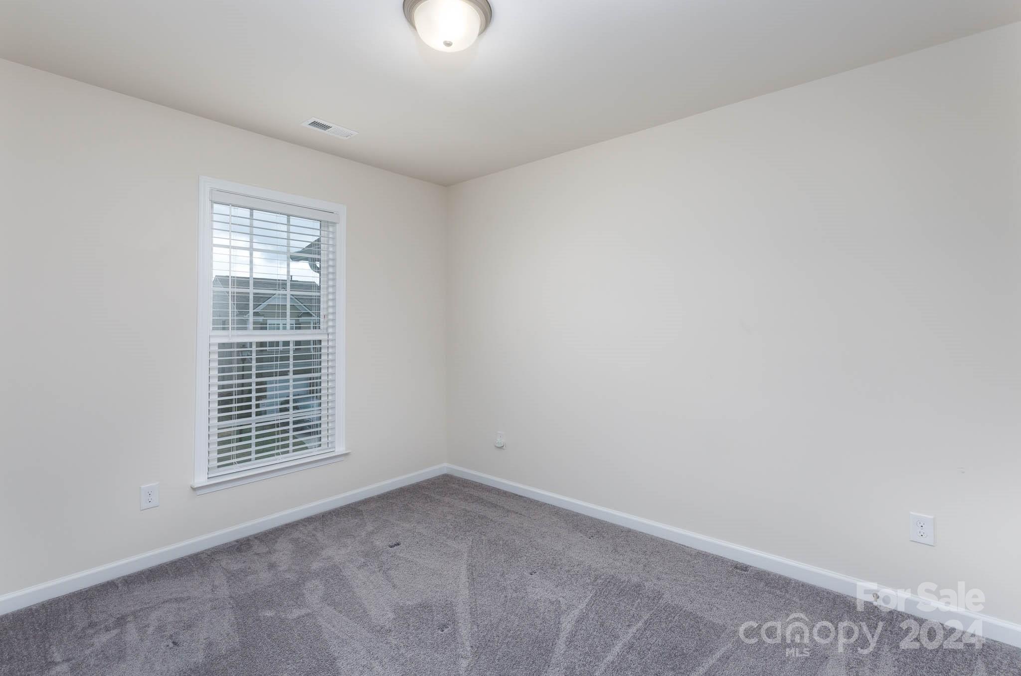 813 Canoe Song Road Fort Mill, SC 29708 - Photo 17 of 26 an empty room with windows