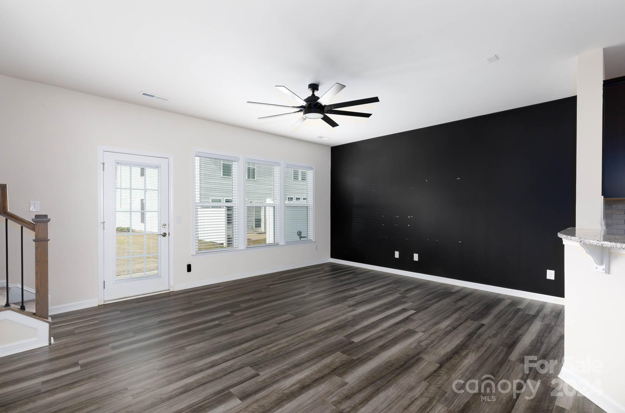 813 Canoe Song Road Fort Mill, SC 29708 - Photo 3 of 26 a view of an empty room with wooden floor and a window