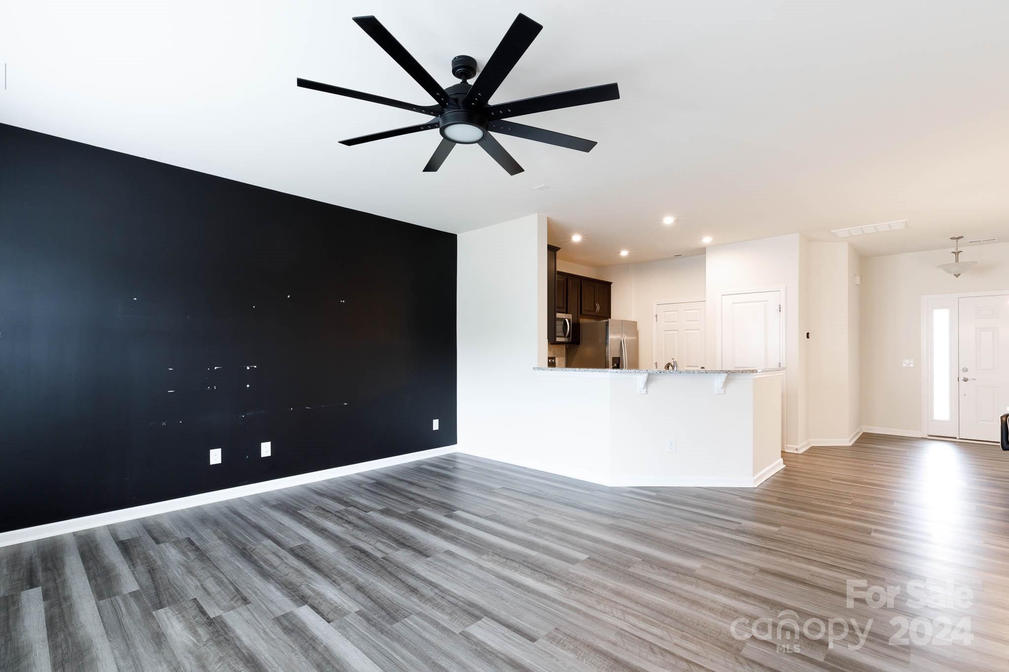 813 Canoe Song Road Fort Mill, SC 29708 - Photo 4 of 26 a view of a big room with wooden floor and windows