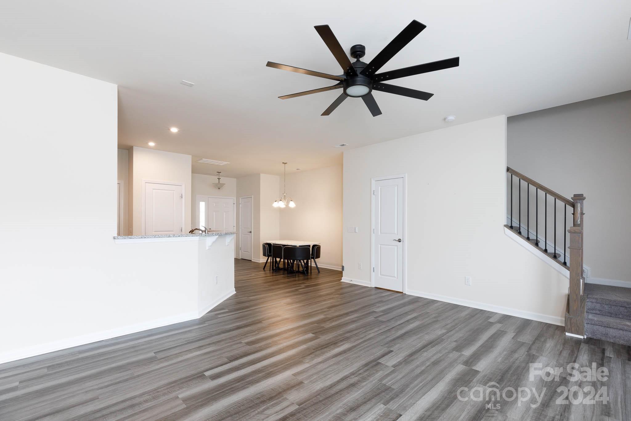 813 Canoe Song Road Fort Mill, SC 29708 - Photo 6 of 26 a view of a livingroom with a hardwood floor and a ceiling fan