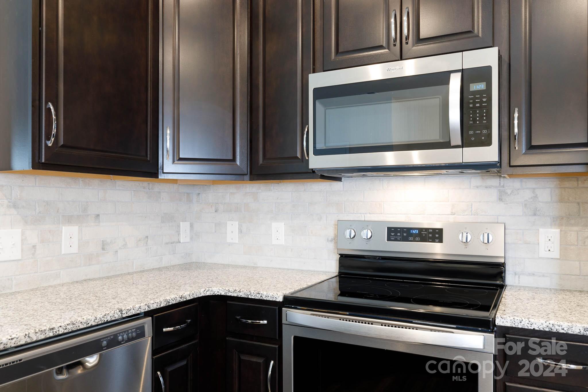 813 Canoe Song Road Fort Mill, SC 29708 - Photo 9 of 26 a kitchen with a stove microwave and sink