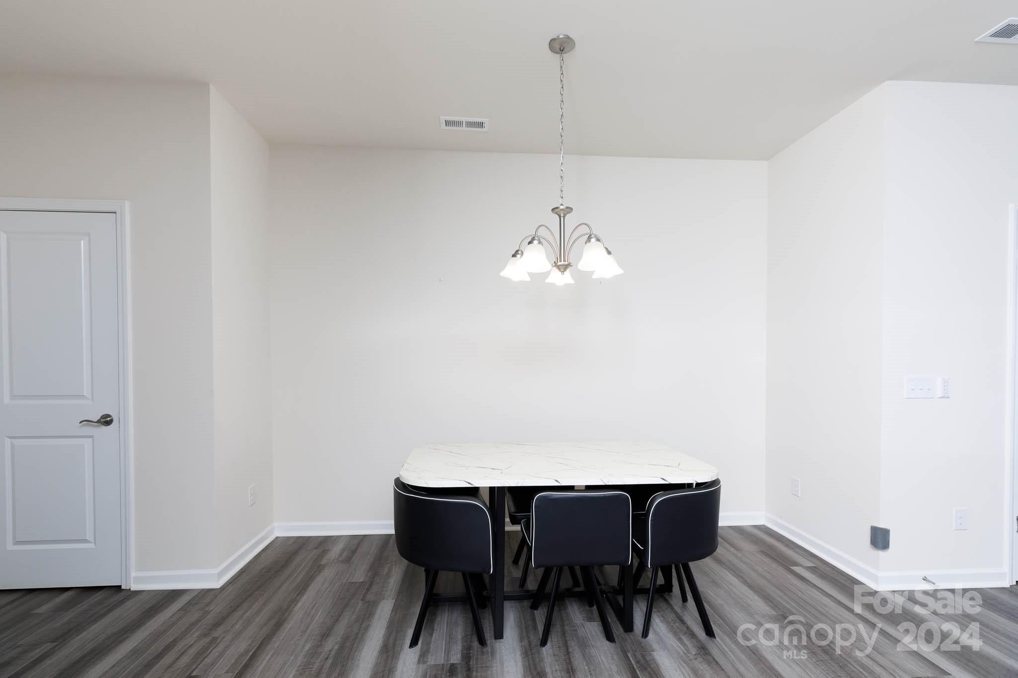 813 Canoe Song Road Fort Mill, SC 29708 - Photo 10 of 26 a view of a dining room with furniture and wooden floor