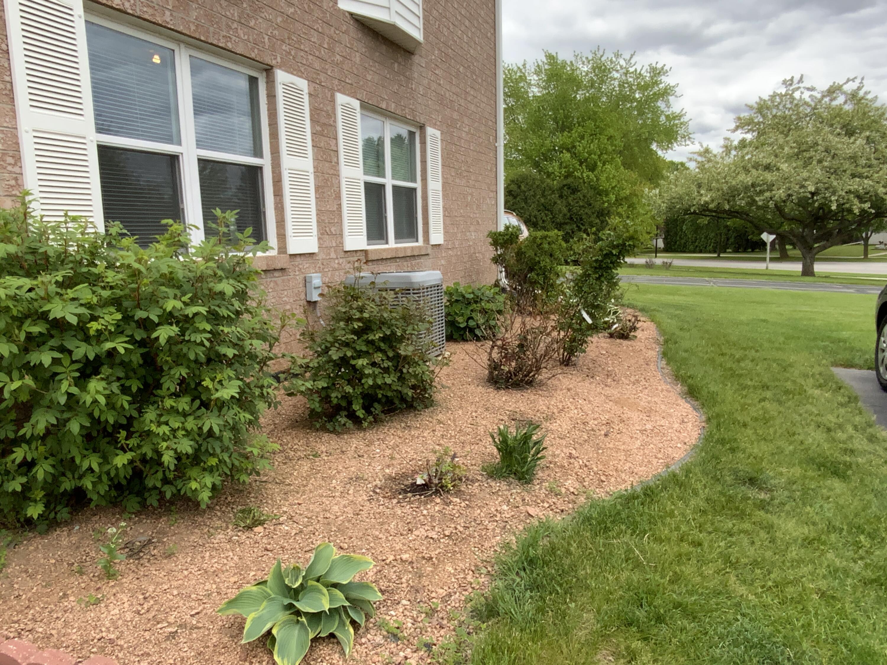 1807 Ridgeway Drive, Unit 38 De Pere, WI 54115 - Photo 37 of 39 front of condo with rose bushes