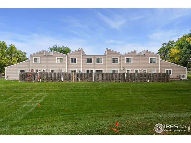 a front view of a house with a garden and yard