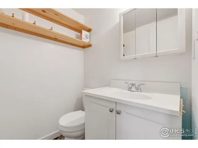 an empty room with a window and a ceiling fan