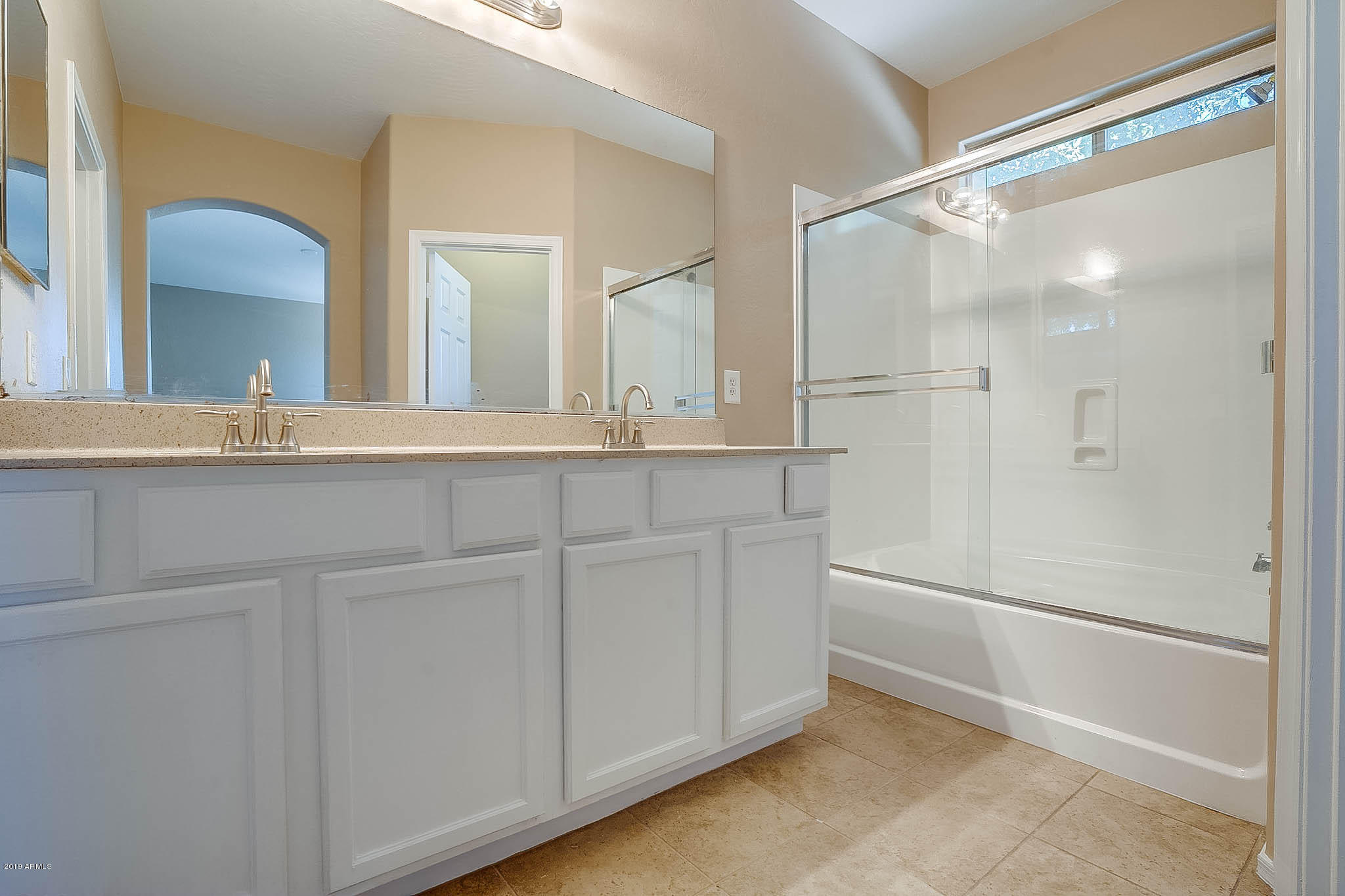 8754 West Payson Road Tolleson, AZ 85353 - Photo 15 of 19 a bathroom with a double vanity sink mirror and shower