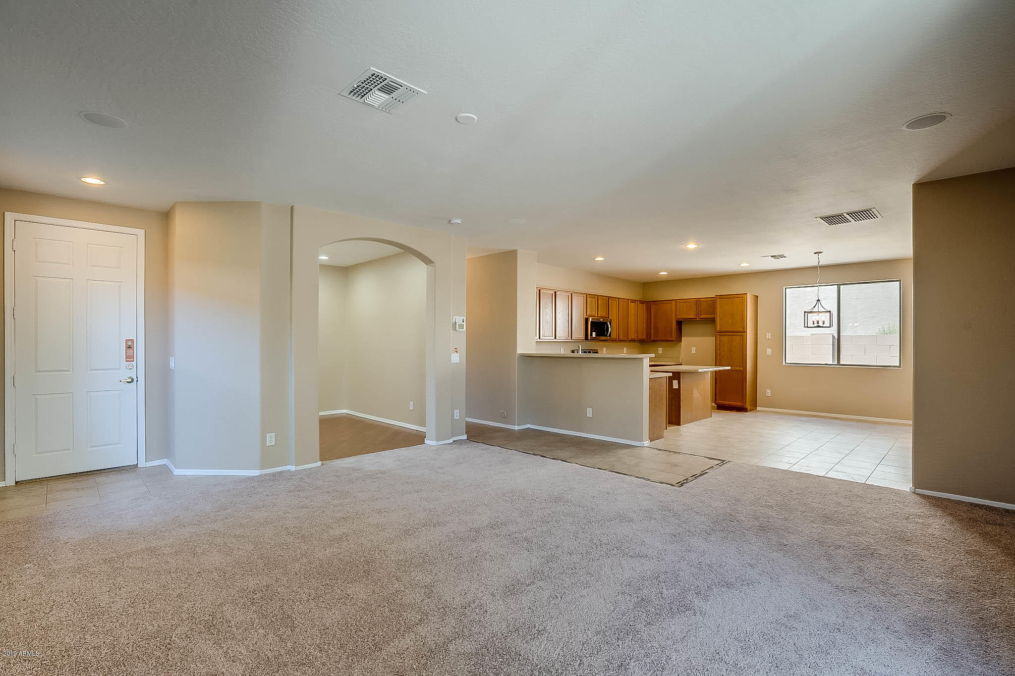 8754 West Payson Road Tolleson, AZ 85353 - Photo 4 of 19 a view of a livingroom with kitchen and furniture