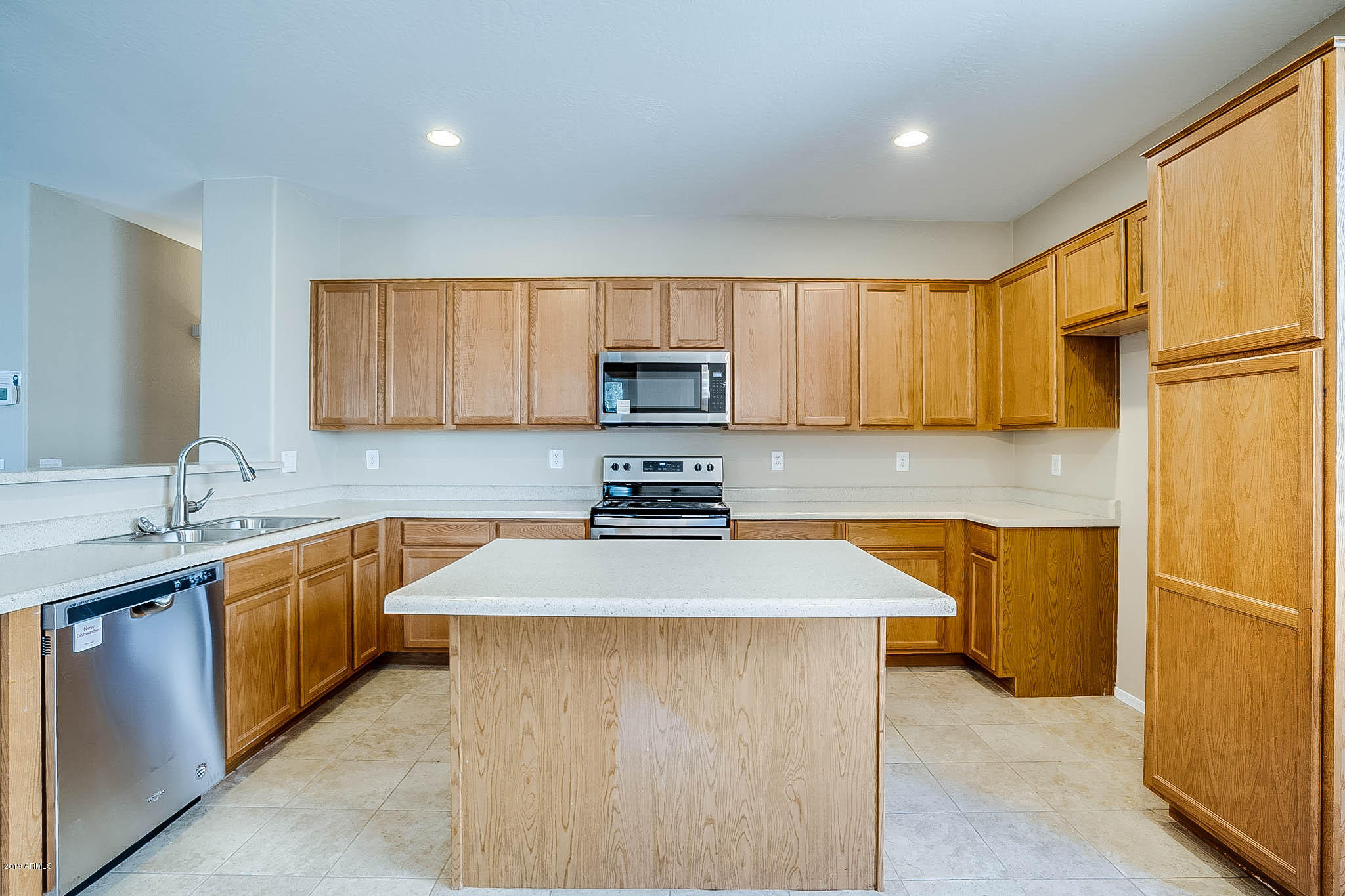 8754 West Payson Road Tolleson, AZ 85353 - Photo 9 of 19 a kitchen with stainless steel appliances granite countertop a sink stove and refrigerator
