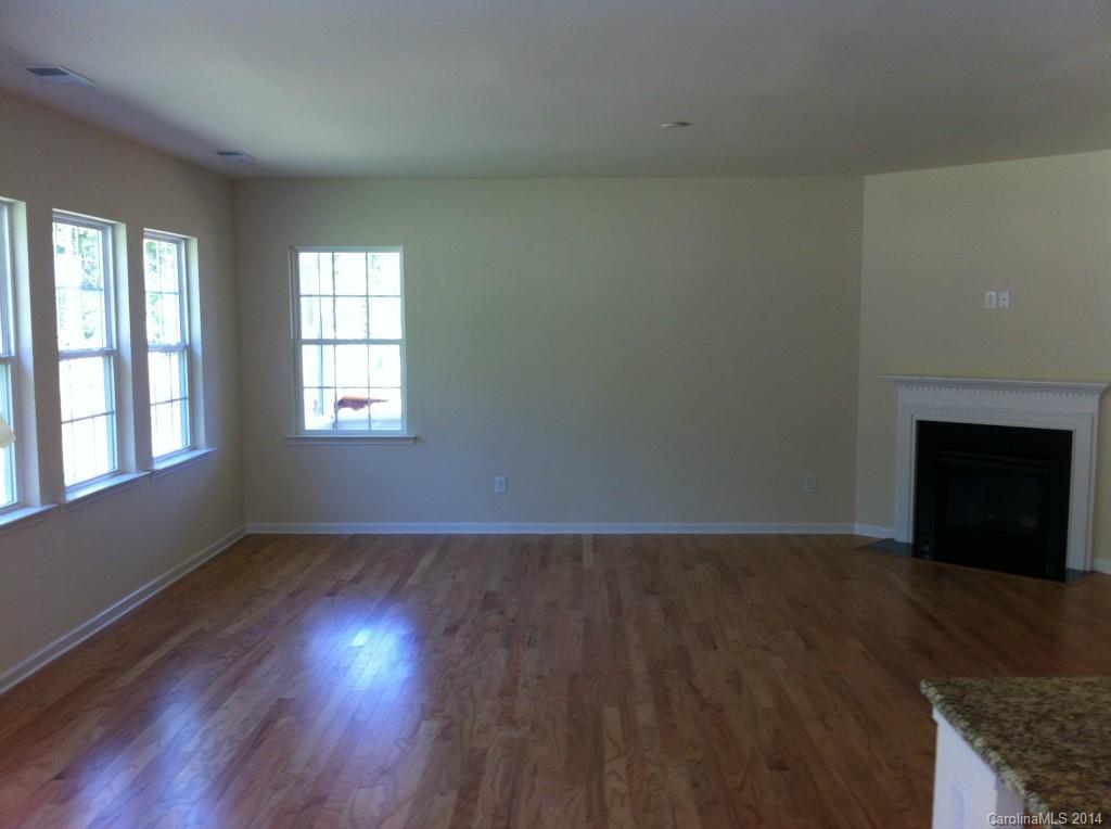 4117 Perth Road, Unit 374 Indian Land, SC 29707 - Photo 7 of 13 an empty room with wooden floor and windows