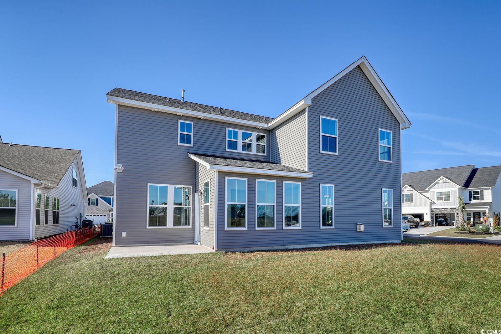 719 Enchantment Loop Myrtle Beach, SC 29588 - Photo 35 of 40 Rear view of house featuring a yard and a patio