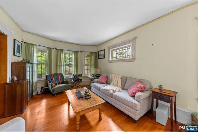 a living room with furniture and a floor to ceiling window