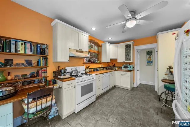a kitchen with stainless steel appliances granite countertop a stove and a refrigerator