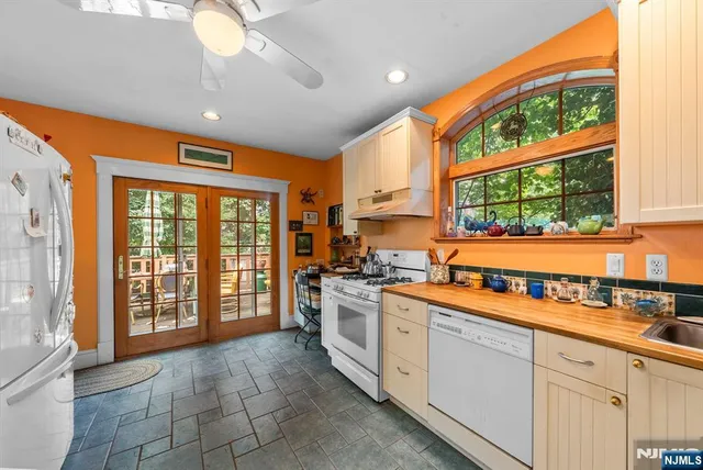 a open kitchen with stainless steel appliances granite countertop a sink and cabinets