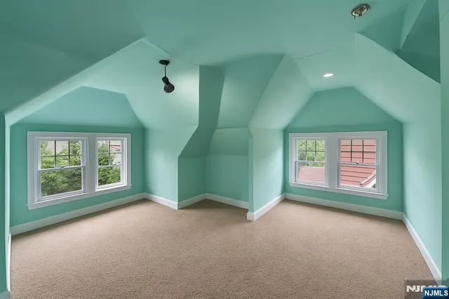 an empty room with windows and entrance