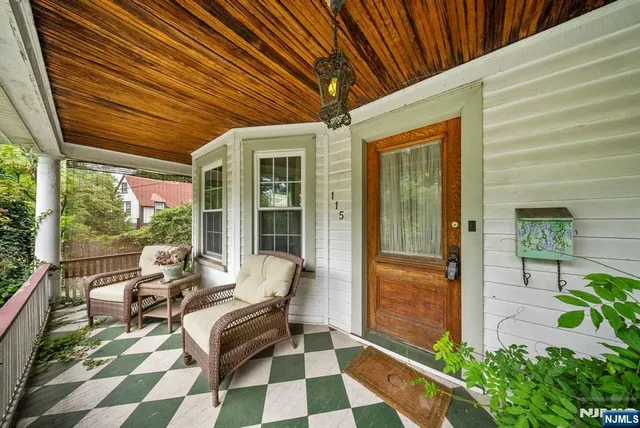 a balcony with furniture and a potted plant