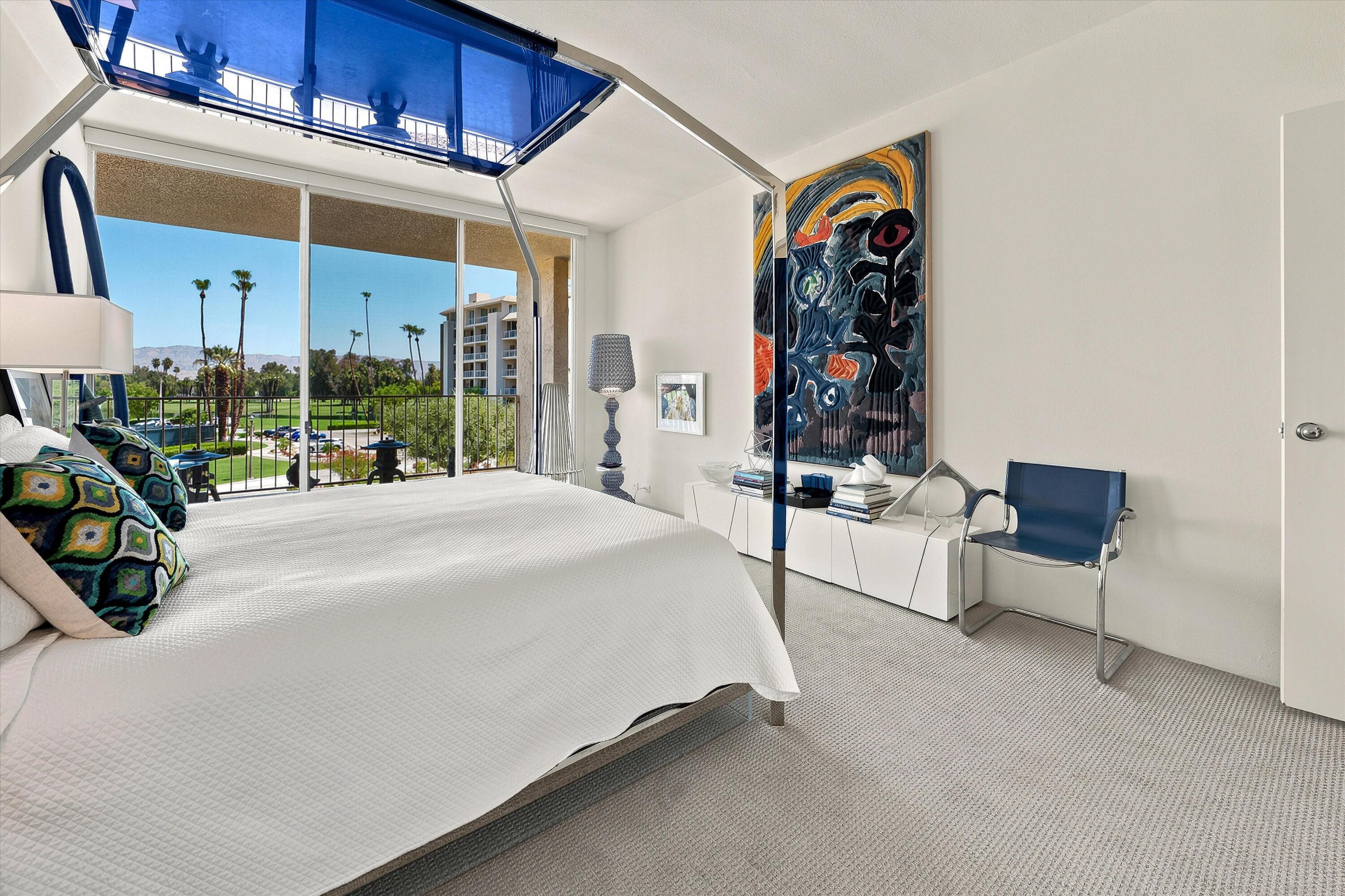 899 Island Drive, Unit 304 Rancho Mirage, CA 92270 - Photo 11 of 30 a bed room with a bed and a chair