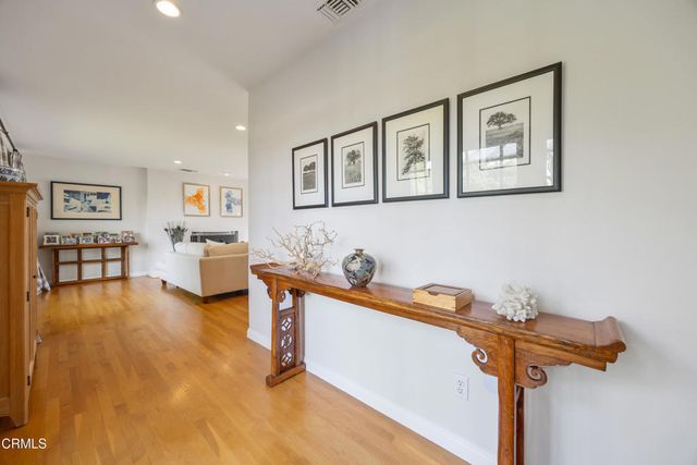 a view of a livingroom with an entryway and wooden floor