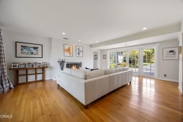 a living room with fireplace furniture and a fireplace