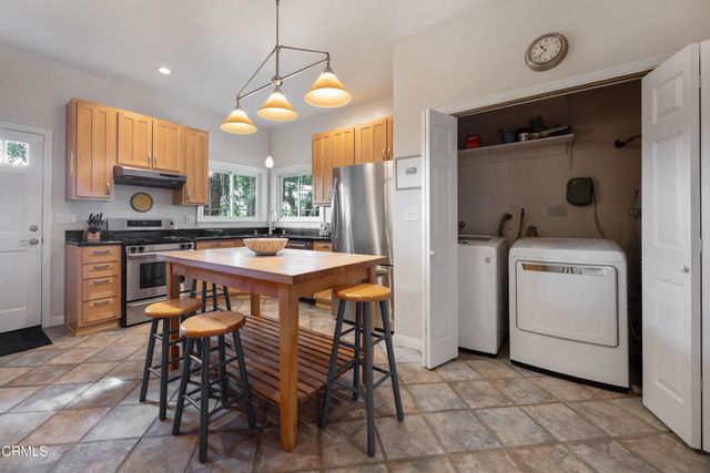 a view of a room that has a table and chairs in it