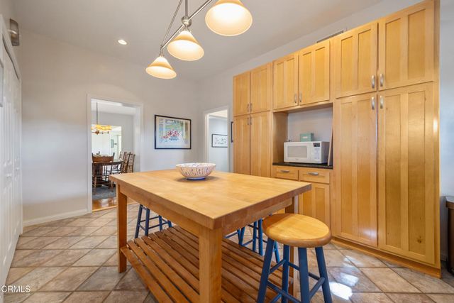 a bedroom with a bed and a dresser next to a window
