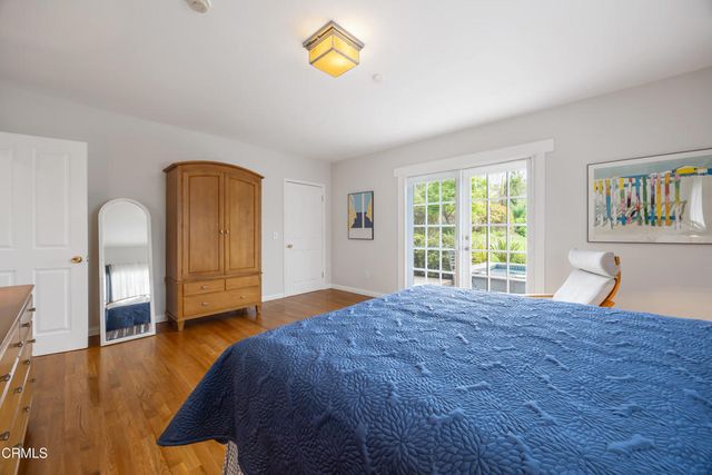 a bedroom with a bed and glass window