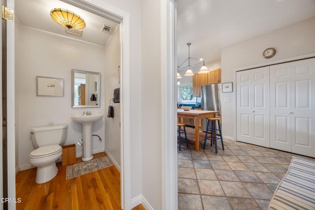 a bathroom with a granite countertop sink mirror vanity and toilet