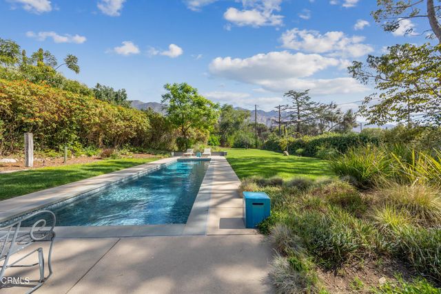 a view of house with backyard space and garden
