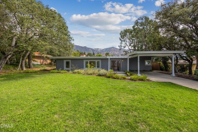a view of house with backyard outdoor seating and yard