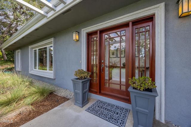 a front view of a house with outdoor seating