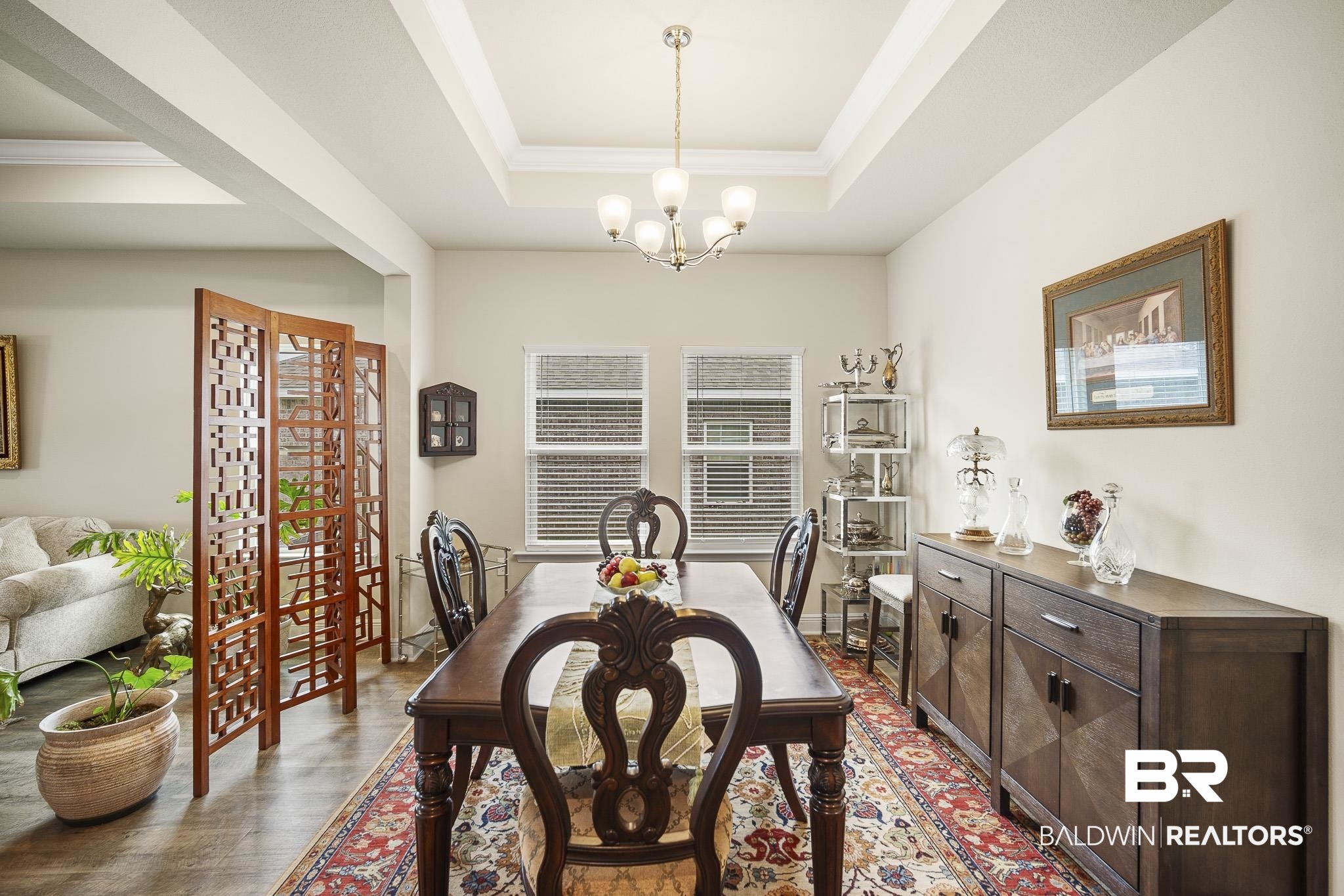 24765 Spectacular Bid Loop Daphne, AL 36526 - Photo 22 of 45 Dining space with crown molding, hardwood / wood-style floors, a chandelier, and a tray ceiling