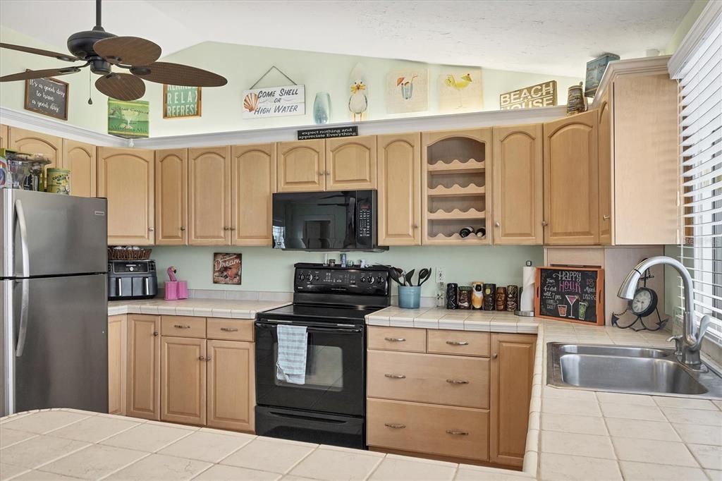 261 Bocilla Drive Placida, FL 33946 - Photo 14 of 43 a kitchen with cabinets a sink and appliances